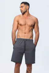 Man wearing gray shorts on a white background