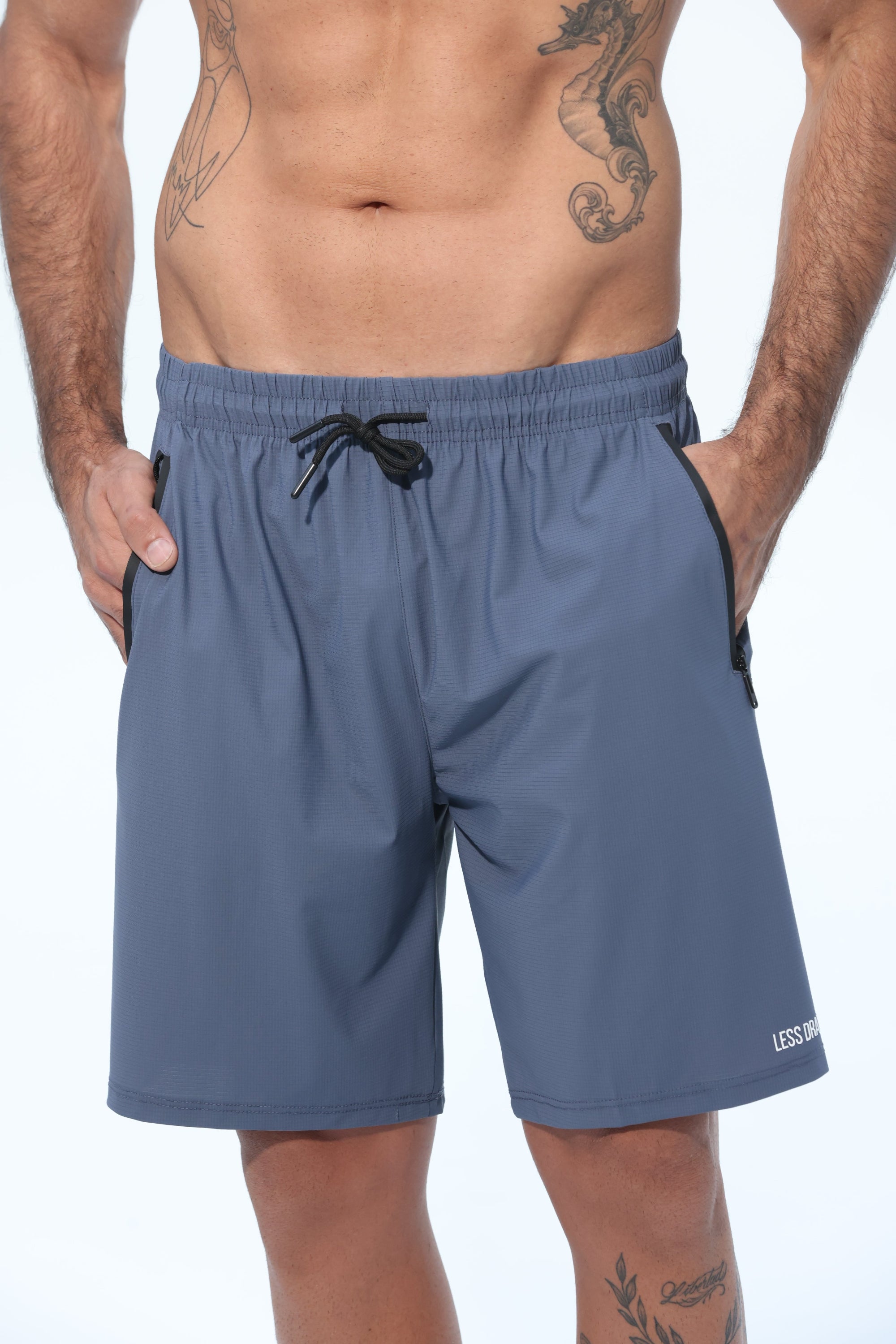 Person wearing blue athletic shorts on a white background