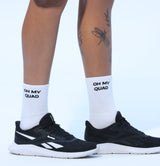 Person wearing black sneakers and white socks with text on a light blue background