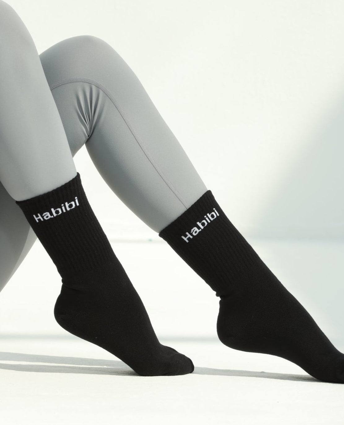 Black socks with visible branding on a white background